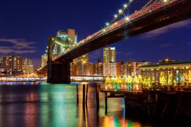 Brooklyn Köprüsü'nün closeup New York'un Manhattan'ın gece ışıkları ile