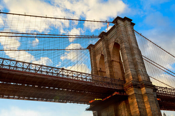 Clouds above Brooklyn Bridge, wide angle view - New York Brooklyn Bridge pylon