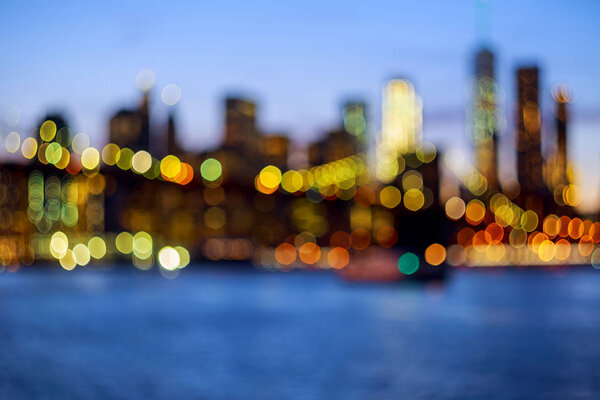 Defocused view of New-York City downtown from Brooklyn at evening