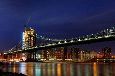 Manhattan Bridge illuminated at dusk very long exposure clipart