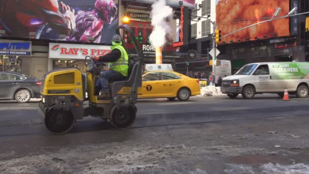 NEW YORK CITY - March 16, 2017 Urban road is under construction, asphalting of yellow roller — Stock Video