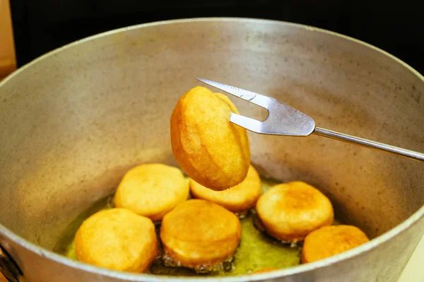 Donut frying in oil, close up video