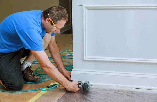 Handyman nailed up Picture Moulding wall in the new house — Stock Photo, Image