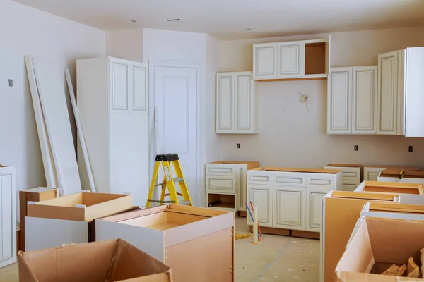 Custom kitchen cabinets in various stages of installation — Stock Photo, Image