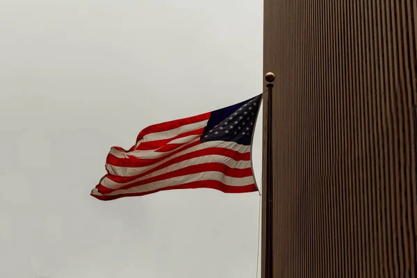 View of American flag on blue building background — Stock Photo, Image