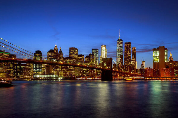 New york city Brooklyn bridge - downtown at night Hudson River with skyline after sunset night view illuminated