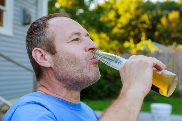 drinks, relax, leisure and people concept - close up of man drinking beer