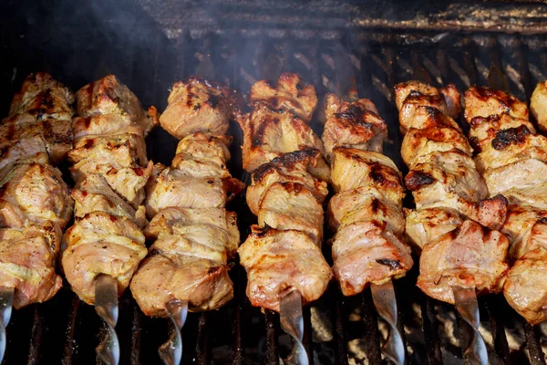 Grilled kebab cooking on metal skewer. Roasted meat cooked at barbecue. — Stock Photo, Image