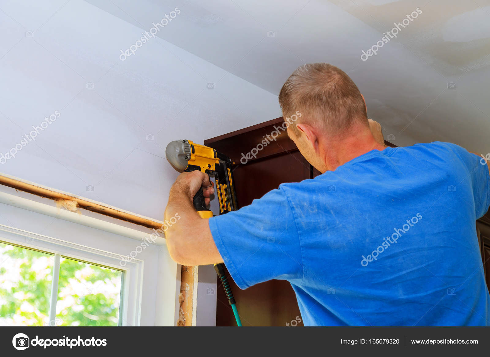Carpenter Brad Using Nail Gun Crown Moulding Kitchen Framing