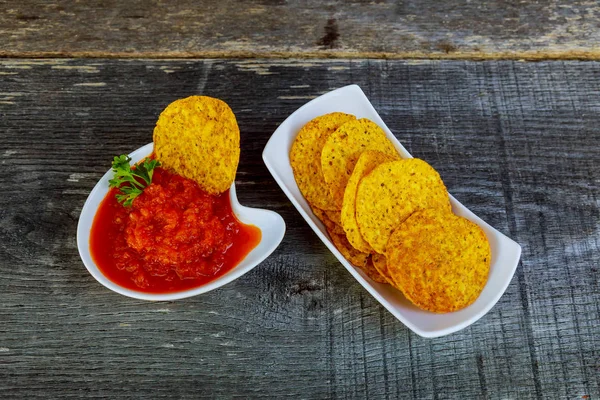 Nachos corn chips with adjika spicy sauce on the table — Stock Photo, Image
