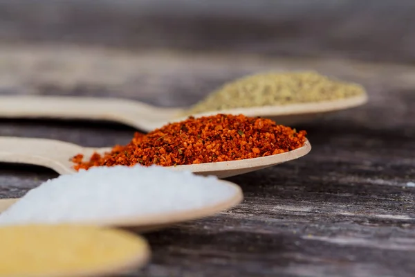 Aromatic spices on wooden spoons. Food ingradients. — Stock Photo, Image