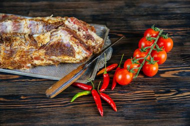 Çiğ et. Çiğ domuz eti bir kesim üzerinde kurulu sebze ve siyah arka plan üzerine baharat.