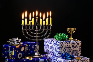 Nine burning candles on blurred background. Hanukkah concept clipart