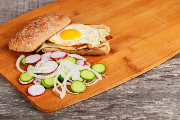 sandwich with bacon and chicken egg with radish and onion cucumbers