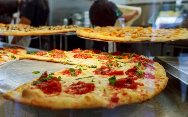 Erime ile lezzetli taze sıcak İtalyan pizza dilim peynir New York City pizzacı penceresinde taze İtalyan pizza