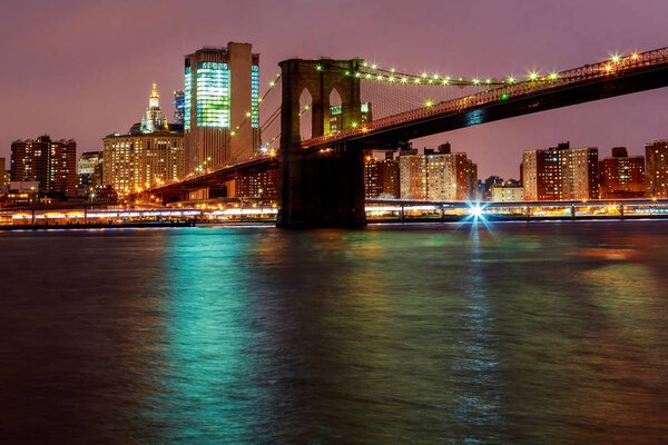 Skyline of downtown New York Lights on Brooklyn Bridge New York City, USA