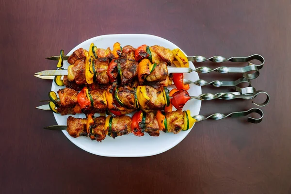 Grilled kebab cooking on metal skewer closeup. Roasted meat cooked at barbecue. BBQ fresh beef meat chop slices. — Stock Photo, Image