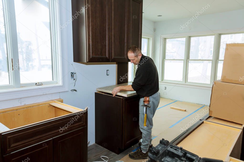 Contractor installing a laminate counter top during a kitchen remodel