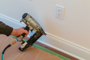 Gauge Finish Nailer man nailed slats custom house building contractor up a wall section for luxury custom house clipart
