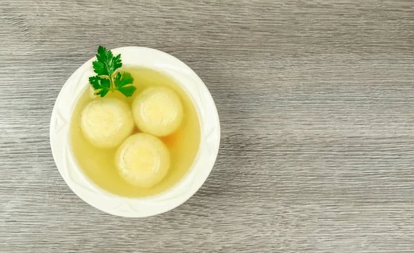 Matzah balls in a bowl of soup — Stock Photo, Image