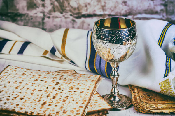 Matzo for Passover with metal tray and wine on table