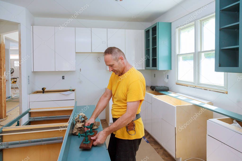 Kitchen Remodel Beautiful kitchen man assembling kitchen furniture