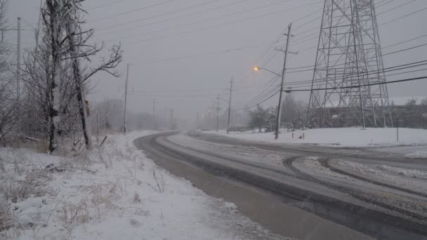 NY USA January 13, 2019: Winter, snow, covered in the road. Car during a Blizzard on the road with the headlights. — Stock Video