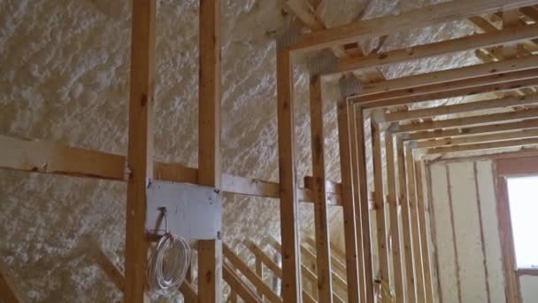 Attic with foam insulation of heating system on the roof of the pipe — Stock Video