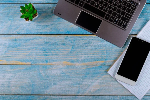 Flat lay office table desk workspace with laptop keyboard, notebook on wood background.