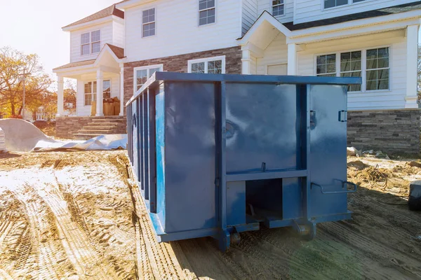 Blu dumpster, odpadkový koš a odpadkové koše poblíž nového staveniště budovy — Stock fotografie