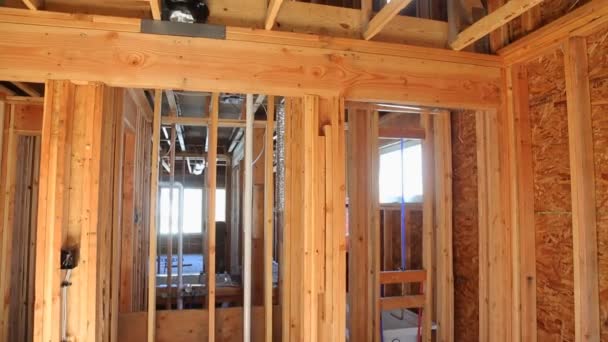 Interior of a new home wooden beams at construction residential house framing — Stock Video