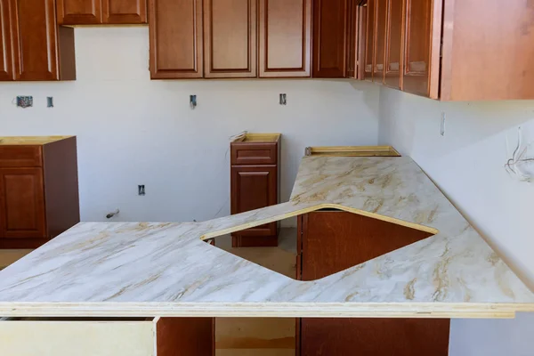 Formica laminate counter top installing a kitchen — 스톡 사진