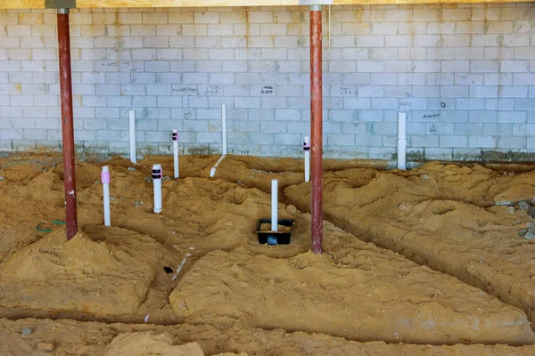 PEX and drain sewer pipes in home basement in the ground — Stock Image PEX and drain sewer pipes in home basement in the ground Stock Picture