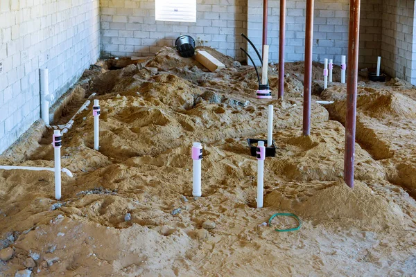 Assembling system of sanitary pvc in the ground sewage pipes basement — Stock Image Assembling system of sanitary pvc in the ground sewage pipes basement Royalty Free Stock Photos