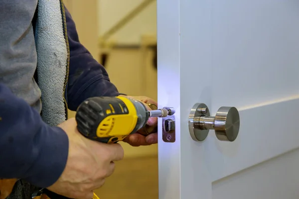 Instalar la perilla de la puerta con un destornillador . —  Fotos de Stock