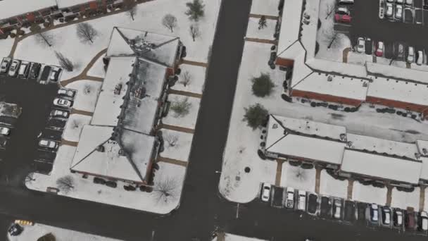 Snow covered rooftops and street in winter aerial view of roads and houses winter landscape. — Stock video