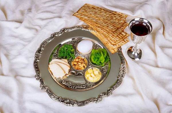 Jewish family celebrating passover matzoh jewish unleavened bread holiday with traditional seder plate