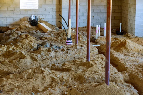 Pipeline with water and sewage new home under construction plumbing system pipes in basement in the ground — Stock Image Pipeline Water Sewage New Home Construction Plumbing System Pipes Basement Stock Photo