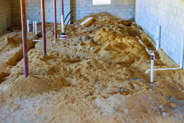 PEX and drain sewer pipes in home basement assembling system of sanitary pipes in the ground — Stock Image Pex Drain Sewer Pipes Home Basement Assembling System Sanitary Pipes Royalty Free Stock Images