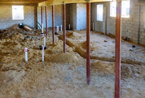 Installing sewer pipe in the ground basement mount a new pipe on the floor — Stock Image Installing Sewer Pipe Ground Basement Mount New Pipe Floor Stock Photo