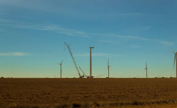 Electric wind turbine windmill installation wind turbine with blue sky background.