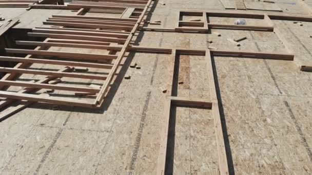 Wood building frame structure on a new development — Stock Footage Wood building frame structure on a new development Royalty Free Stock Footage