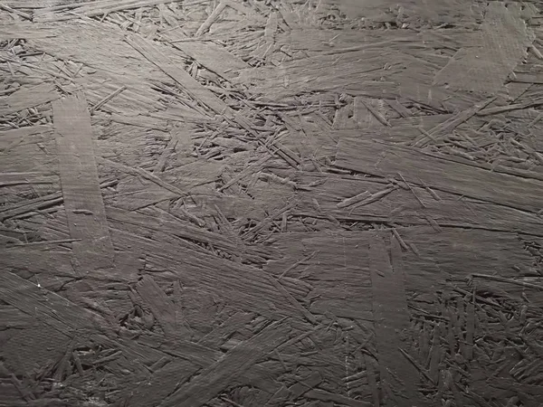 Background of glued wood sawdust painted black, texture