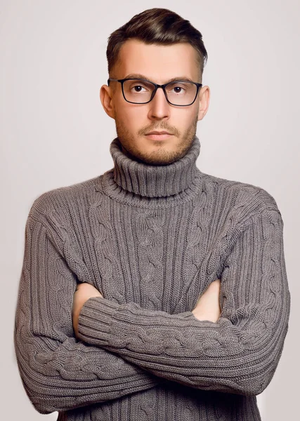 Beautiful fashionable guy with glasses and a sweater posing — Stock Photo, Image