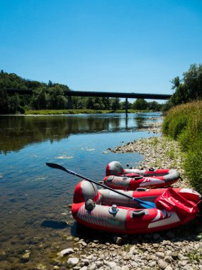 Güzel, doğal bir nehrin kıyısında kürek çeken iki rafting teknesi.