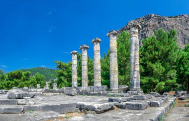 Ruins of the Temple of Athena Polias in the ancient city of Priene, Turkey, on a sunny summer day. Big panoramic shot. clipart
