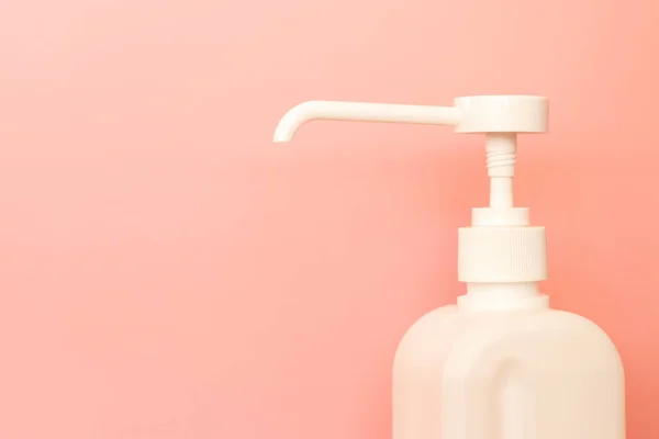 White bottle of hand sanitizer, disinfecting gel on pink background. — Stock Photo, Image