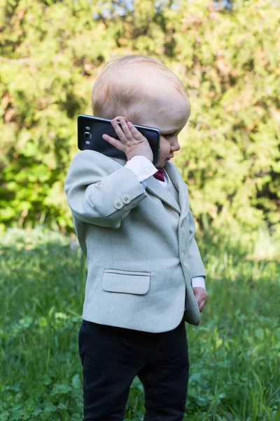 Small Boy Hold Black Mobile Phone Ear Listen — Stock Photo, Image
