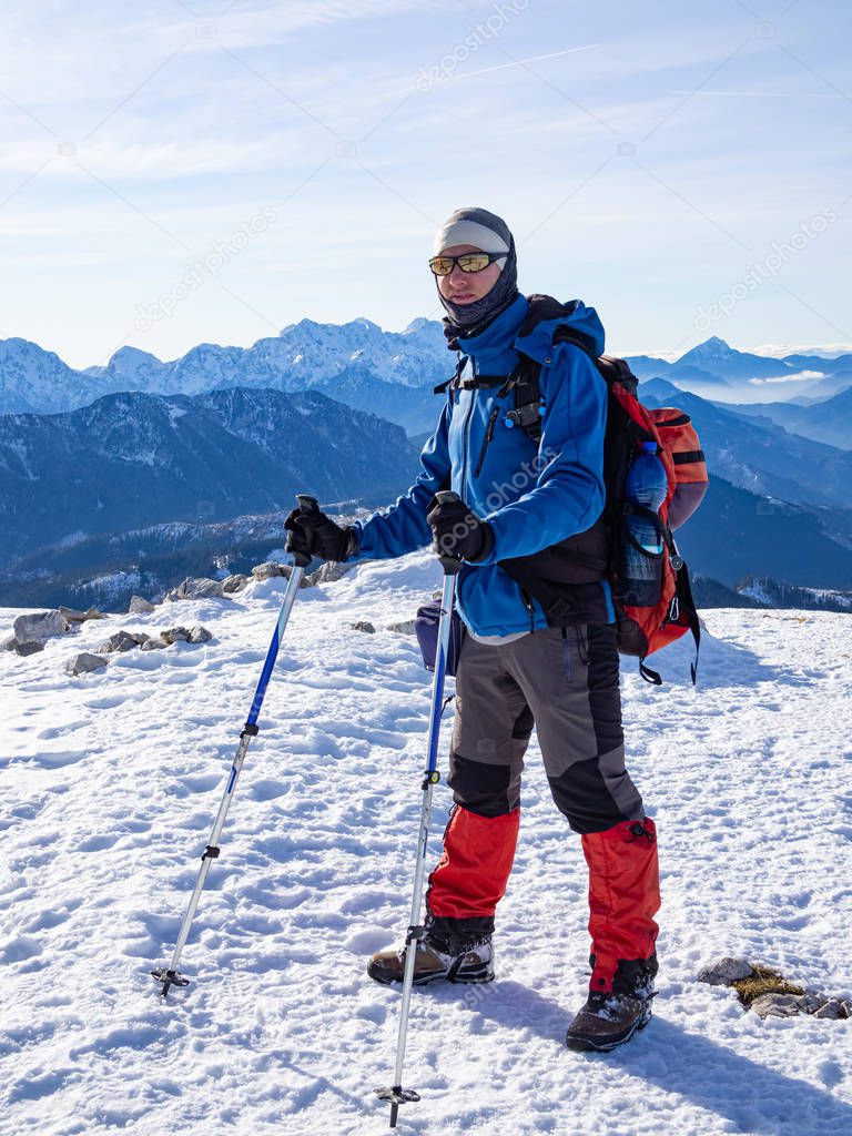 Mountaineer standing at the top of the Peca mountain, Slovenia