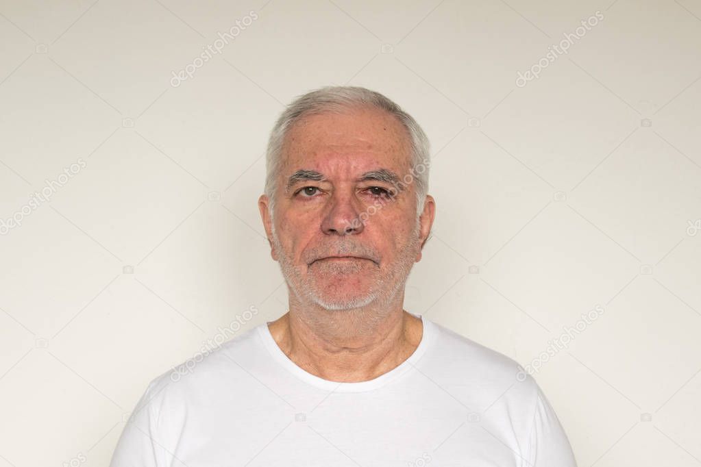 old man senior  white t shirt closeup next to the wall healthy 